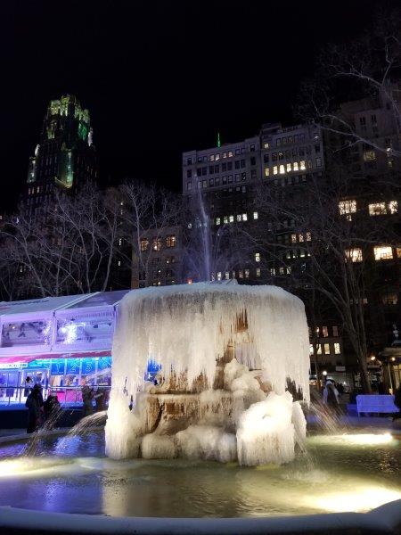 Ice hanging down from the fountain with it practially completely frozen