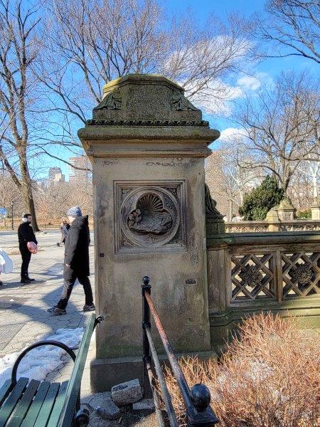 Pillars in Bethesda Terrace with representations of day with the sun