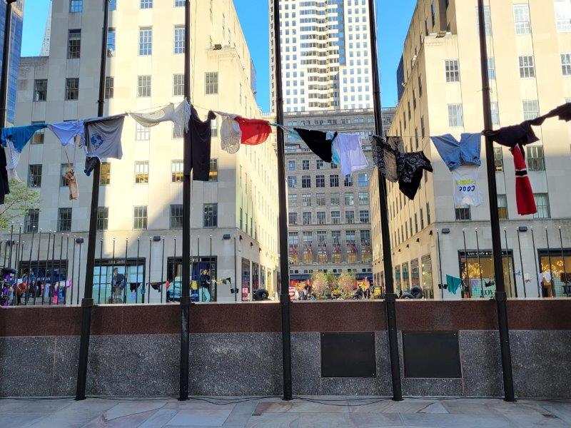 Air Out Your Dirty Laundry Exhibit with laundry hanging from clotheslines at Rockefeller Center