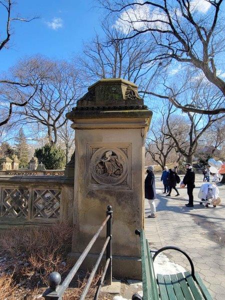 Pillars in Bethesda Terrace with representations of night with a witch on a broom