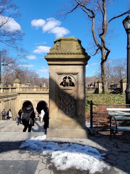 Pillars in Bethesda Terrace with representations of day with a rooster