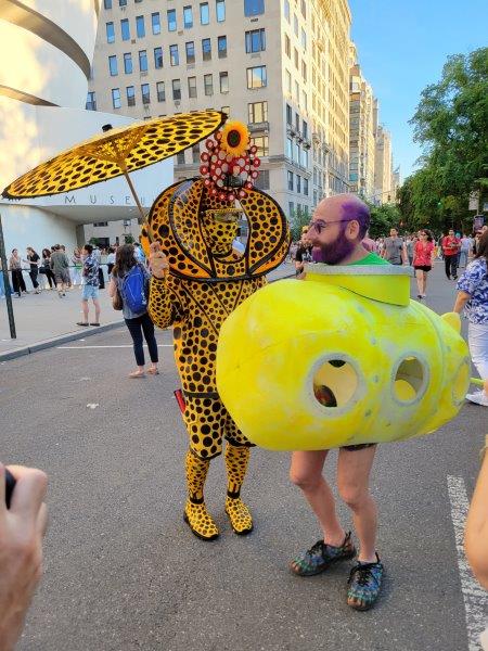 Kusama themed character wearing a yellow outfit with black polka dots