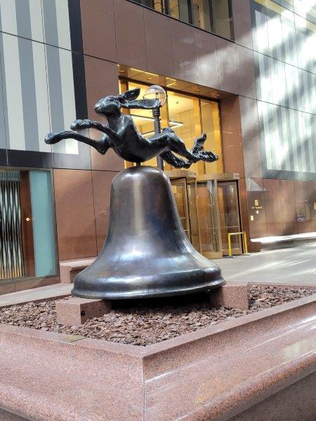 Public art in the corridor with a rabbit on a bell sculpture