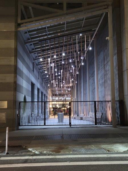 Closed gates blocking pedestrian access at night