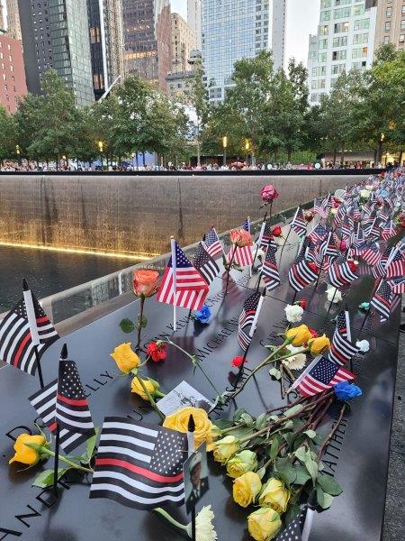 World Trade Center Memorial Pools with flags and flowers in New York on 9/11