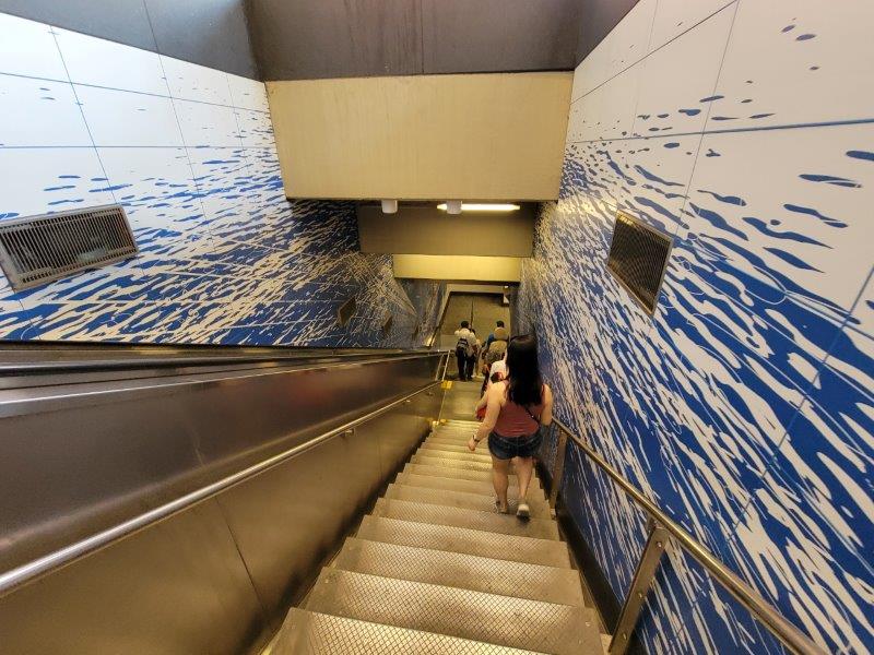 Going down the escalator through the art