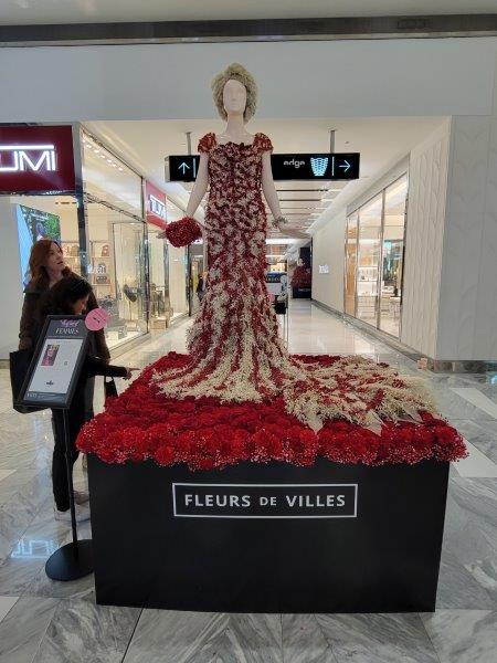 Better Midler  Floral Mannequin  in a red gown with white accents