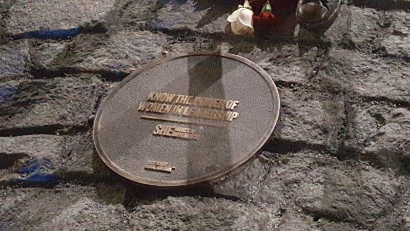 Plaque at her feet which says know the Power of Women in Leadership