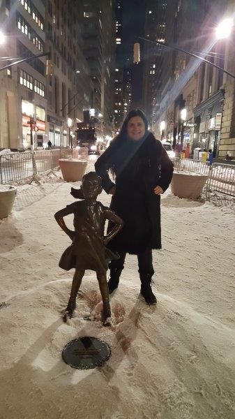 Hanit posing with Fearless Girl in the snow