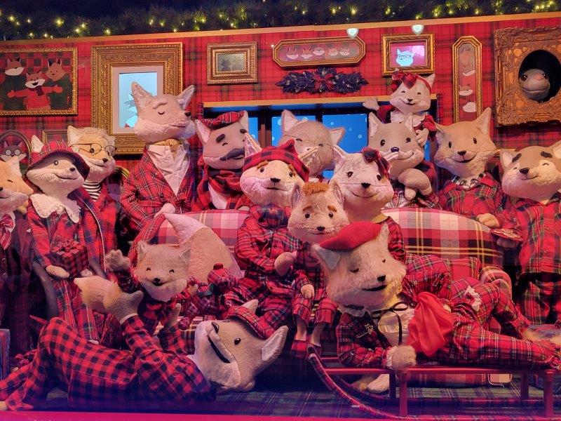 Close up with lots of stuffed animals in red pajamas