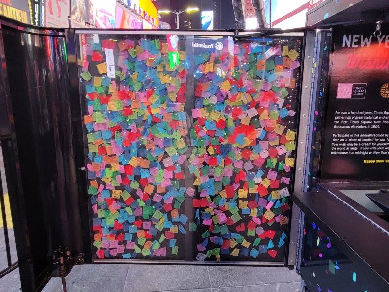 Colored confetti wishes pinned up on a display board 