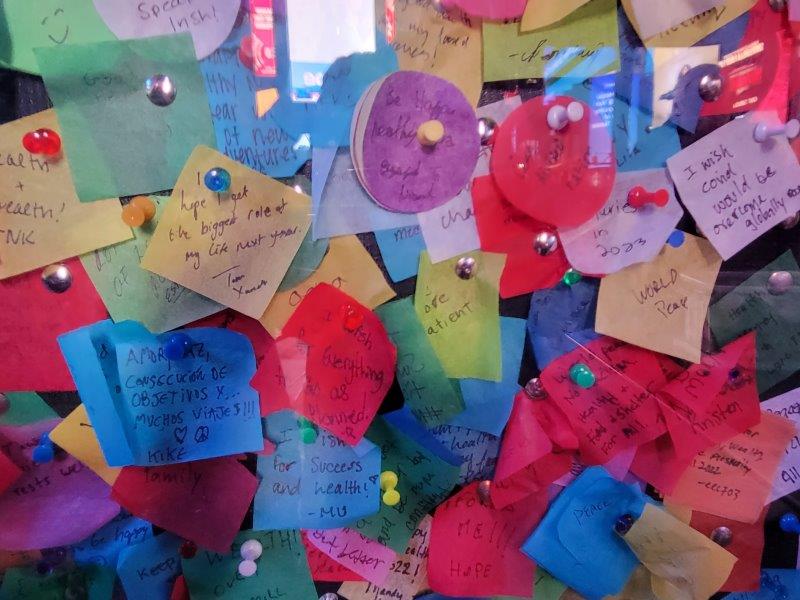 Close up of people's messages pinned up on a board