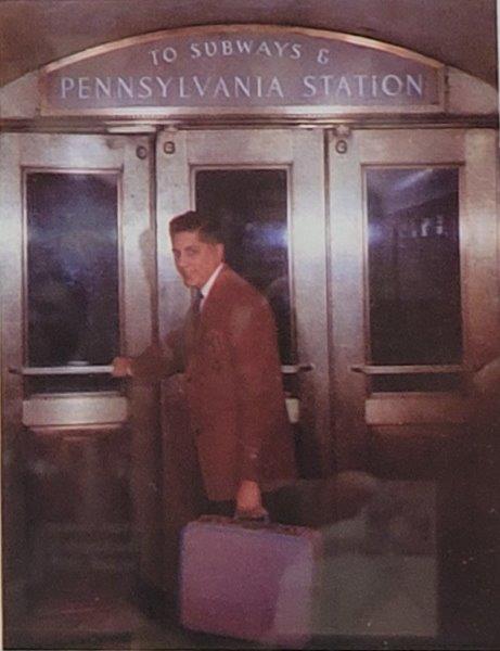 Ad of doorway with a passenger opening the door leading to Subways and Penn Station