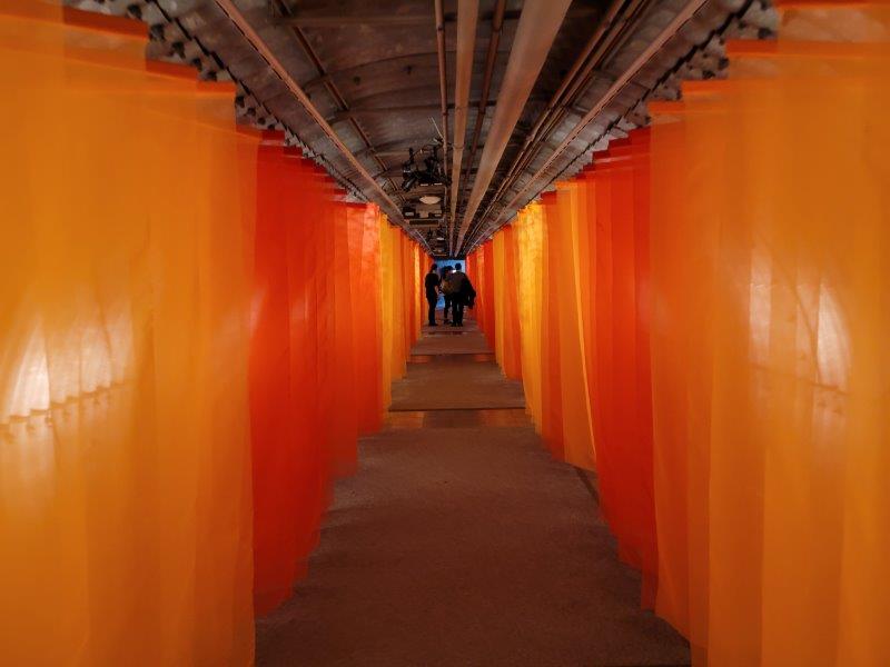 Walkway with orange curtains on each side