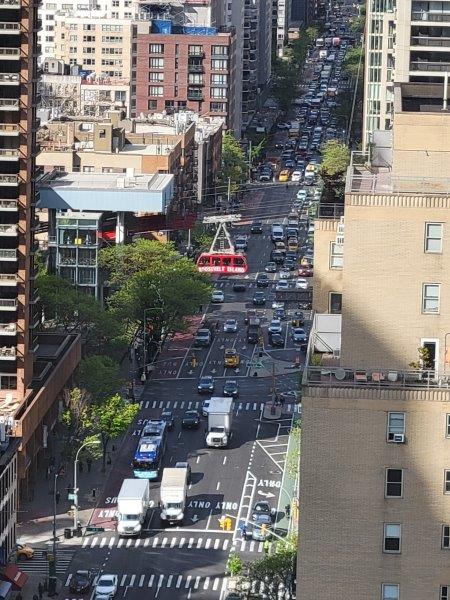 Traffic on Second Avenue with a view of the Roosevelt Island Cable Car