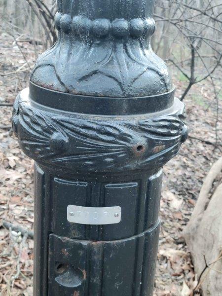 Horizontal Location Code on a Central Park Lamp Post - 7703, which means 77th Street on the West Side