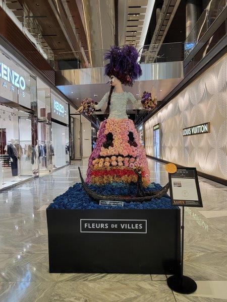 Italy floral mannequin in a structured floral dress and wearing a mask