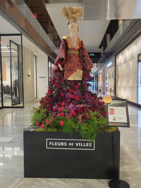 China floral mannequin in a regal looking outfit and gold hat