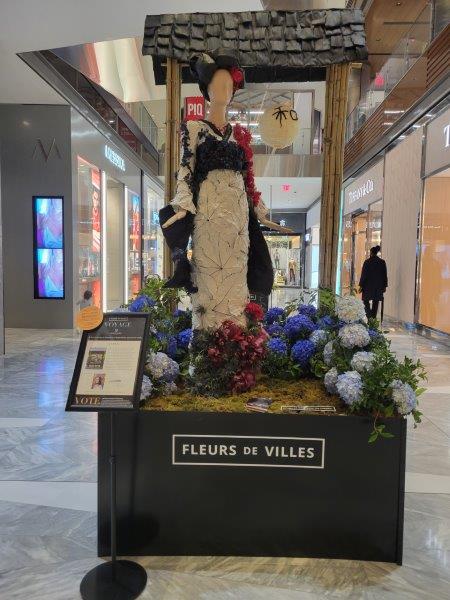 Japan floral mannequin wearing a white kimono with a bloack sash and red accents