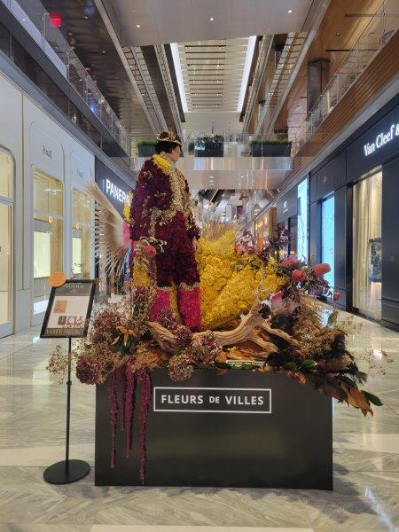 Spain floral mannequin dressed as a matador with a floral cape in reds and yellows