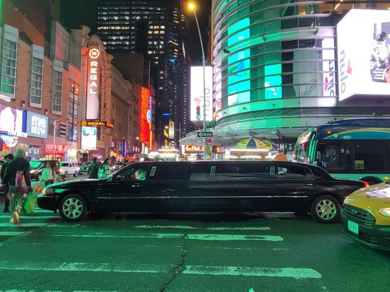 Limousine on the streets of New York with a backdrop of Times Square