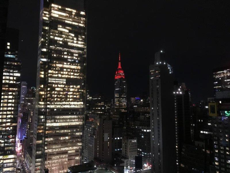 Empire State Building lit up in red by night