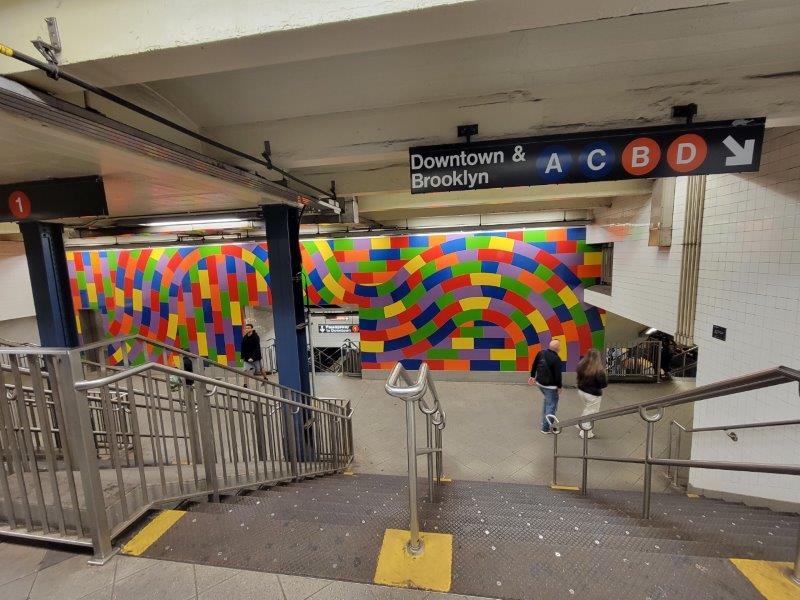 Subway Station in NYC with a board for Downtown and Brooklyn Trains