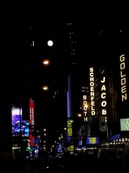 View of a street with Broadway Theaters by night