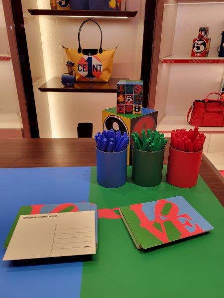 Love Postcards with red, blue and green markers for writing at the store