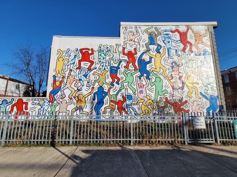 Mural by Keith Haring on the side of a building at the Haring Garden in Philly