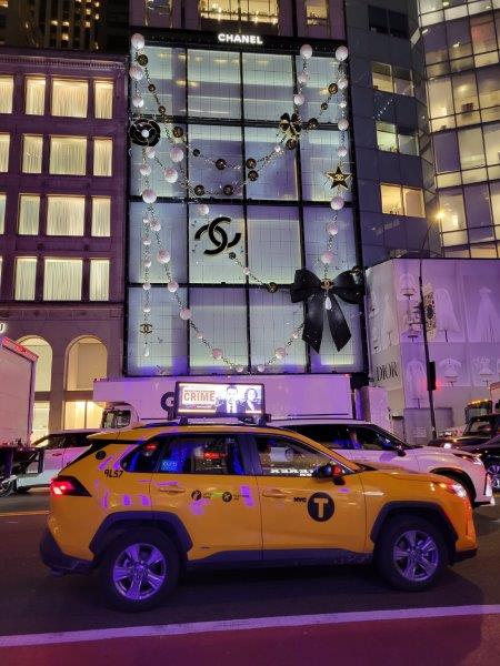 Saks 2023 display with a Chanel necklace draped like the building is wearing one