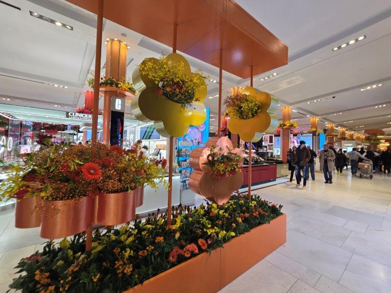 Aisle with floral displays in oranges and yellows