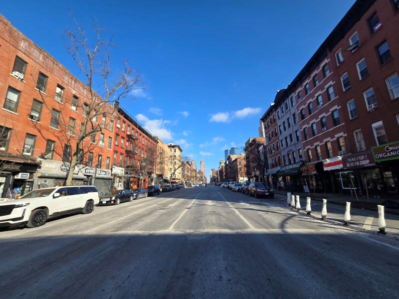 View up 9th Avenue with storefronts on both sides 