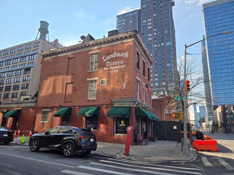 Exterior view of the red brick facade of Landmark Tavern on 11th Avenue 