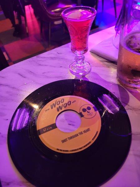 Drink at Woo Woo on a vinyl record