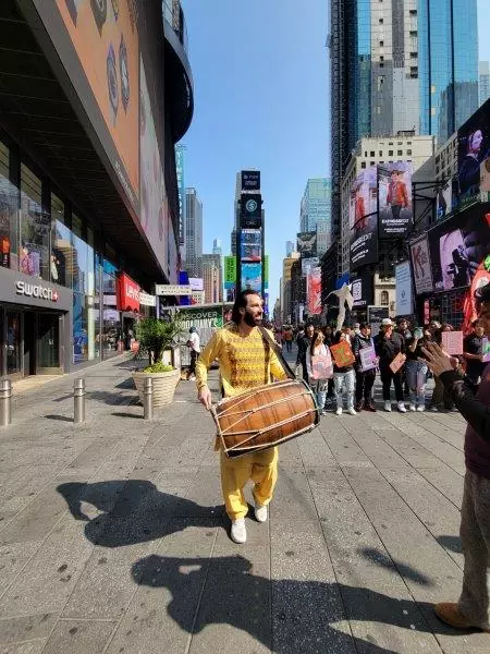 Salar Nadar playing the dhol for Little Amal 