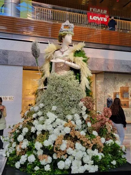 Queen Elizabeth II in a dress made of carnations and other greens