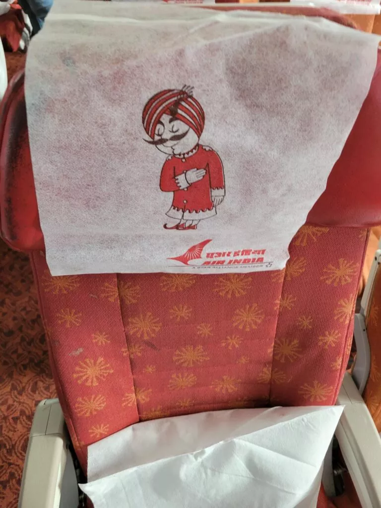 Backrest with Maharaja on Chairs on a flight 